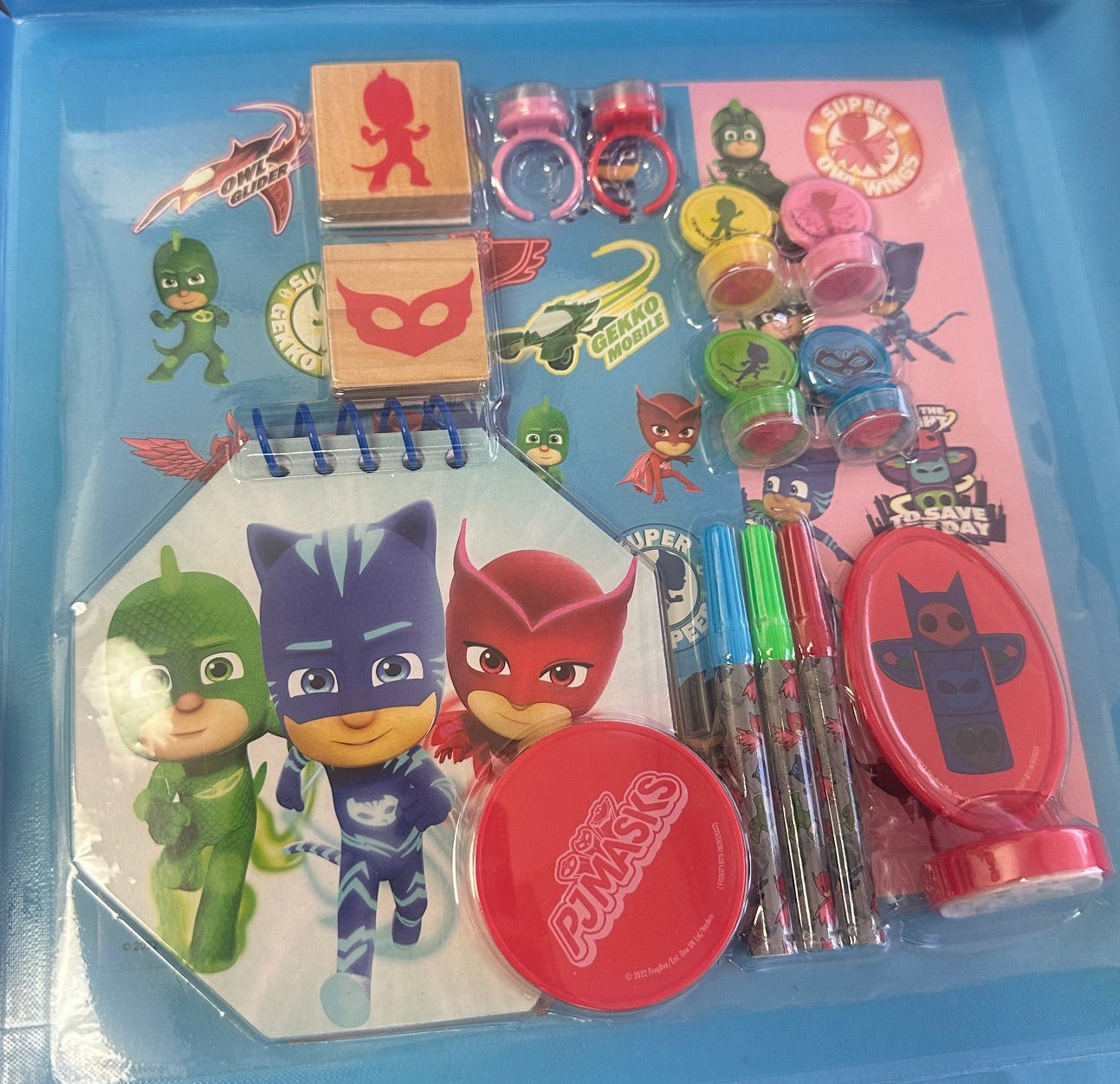Children's stationery set with PJ Masks theme on a blue tray.