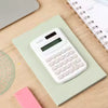 Mini Portable Calculator – Dual Power, 10-Digit Display Mini portable calculator, White, displayed on book