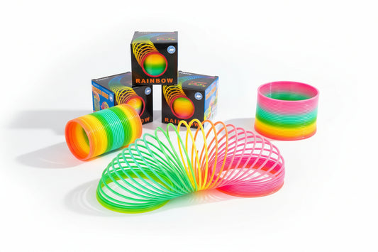 Colorful slinkies and packaging on a white background
