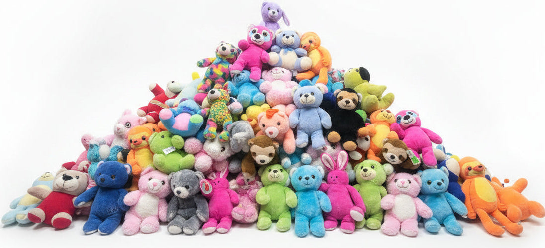 Assorted colorful plush toys on a table in a warehouse setting