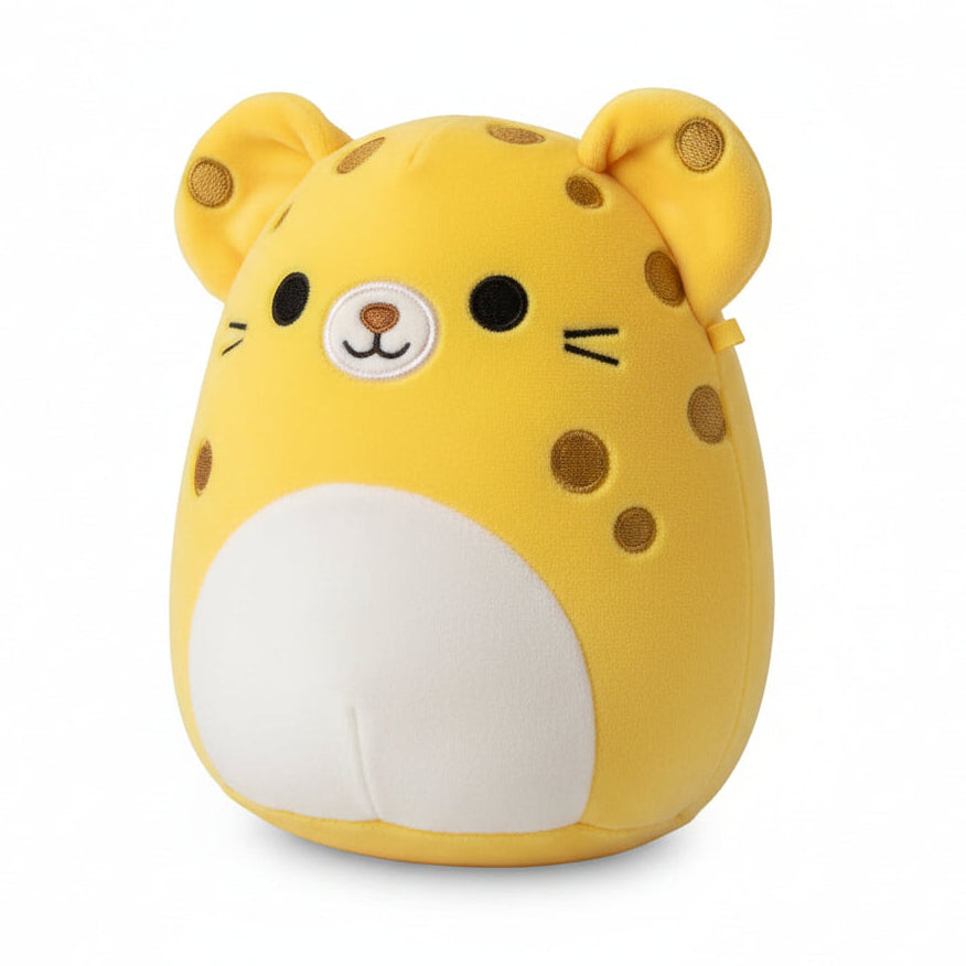 Yellow plush toy with a white patch on a wooden surface