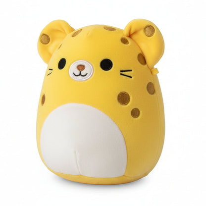Yellow plush toy with a white patch on a wooden surface