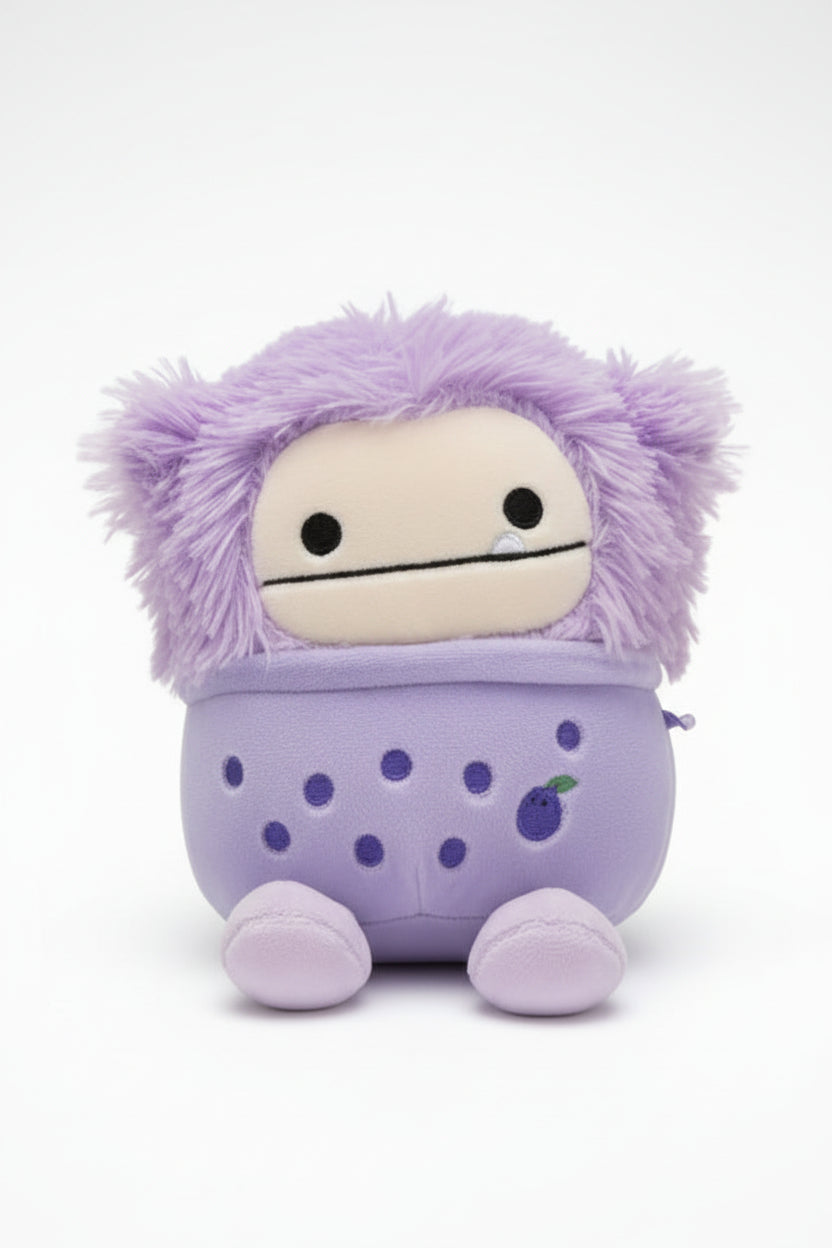 Purple plush toy with a polka dot bag on a white background