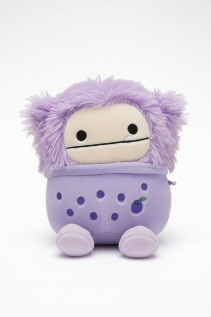 Purple plush toy with a polka dot bag on a white background