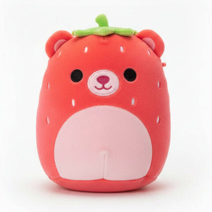 Red plush toy with a white belly on a wooden surface