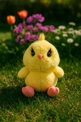 Che’Lashies Soft Stuffed Chick Plush toy in a garden setting with colorful flowers and bright sunlight.