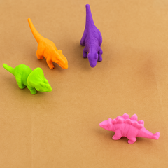 Four colorful dinosaur toys on a brown background