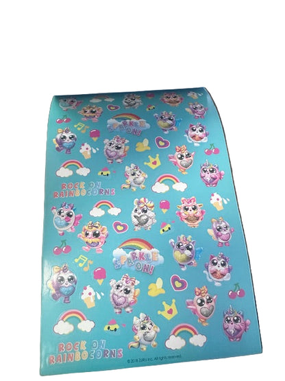 Sheet of colorful stickers with cartoon characters on a blue background, held open by a book.