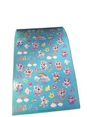 Sheet of colorful stickers with cartoon characters on a blue background, held open by a book.