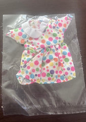 Colorful polka dot bow on a clear plastic bag with a dark background