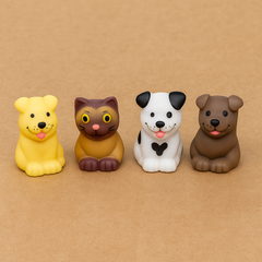 Four colorful animal figurines on a brown background