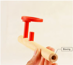 Floating ball game being blown