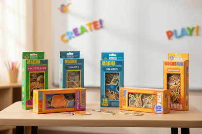  Boxes of magnets shaped like animals or shapes, on a desk in classroom