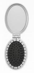 Compact mirror with black bristle brush on a white background