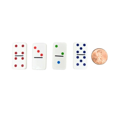 Four domino pieces with colored dots next to a penny on a white background
