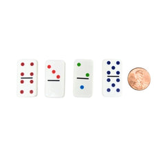 Four domino pieces with colored dots next to a penny on a white background