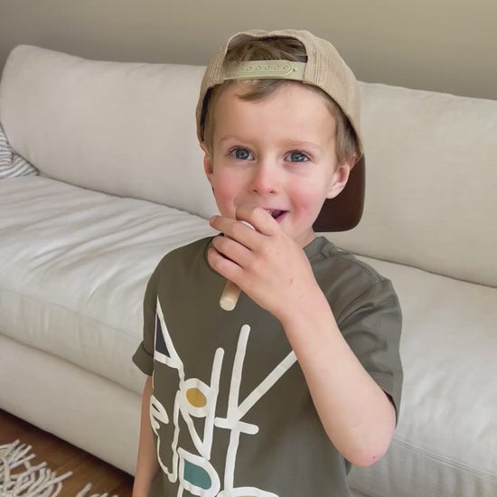 boy playing with the wooden floating ball pipe game