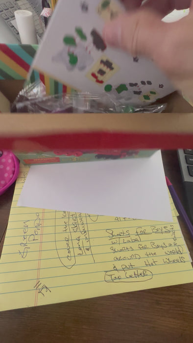 opening and unpacking a box with blocks inside to build a train toy