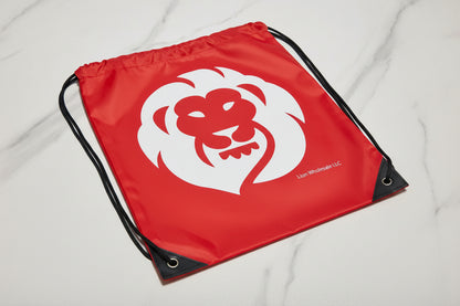 red drawstring bag with a white lion logo on a light gray background