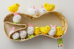 Selection of wind up chicks and bunnies sitting on a rabbit shaped basket